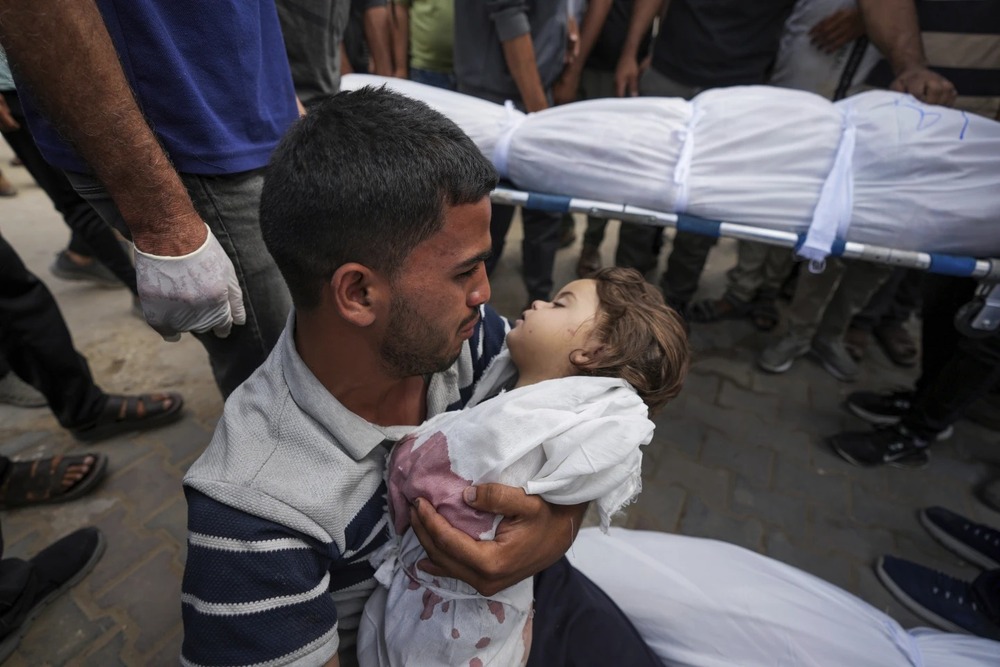 Karam Harara holds the body of his 2-year-old daughter Sabreen, who was among 20 people, mostly women and children, killed in an Israeli airstrike in central Gaza, before her funeral at the Al-Aqsa Martyrs Hospital in Deir al Balah, Gaza Strip, Sunday, May 19, 2024. (AP) Karam Harara holds the body of his 2-year-old daughter Sabreen, who was among 20 people, mostly women and children, killed in an Israeli airstrike in central Gaza, before her funeral at the Al-Aqsa Martyrs Hospital in Deir al Balah, Gaza Strip, Sunday, May 19, 2024. (AP)