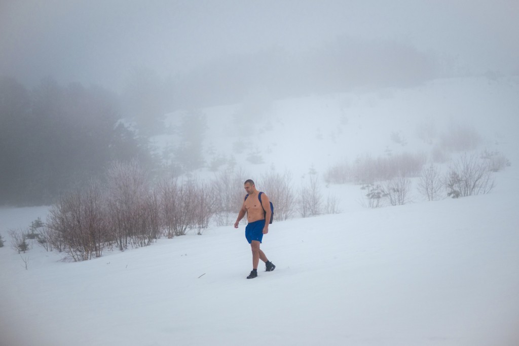 Photo by OLIVER BUNIC / AFP  Serbian archaeologist Vladimir Stevanovic, known on social media as "Serbia's Iceman", hiking wearing only boots, shorts and a backpack on thick snow at the Besna Kobila mountain in Serbia's far south, near the city of Vranje, on January 30, 2026.