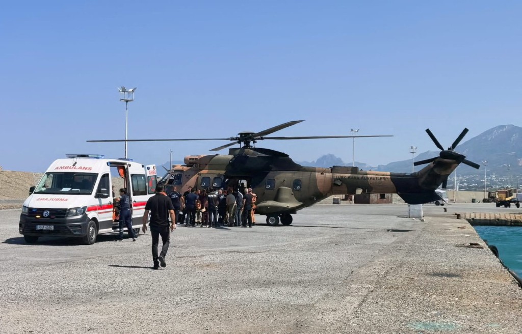 A helicopter brings survivors ashore after they were rescued from the sea following a boat capsize off Kyrenia, northern Cyprus, August 30, 2026. (Reuters)