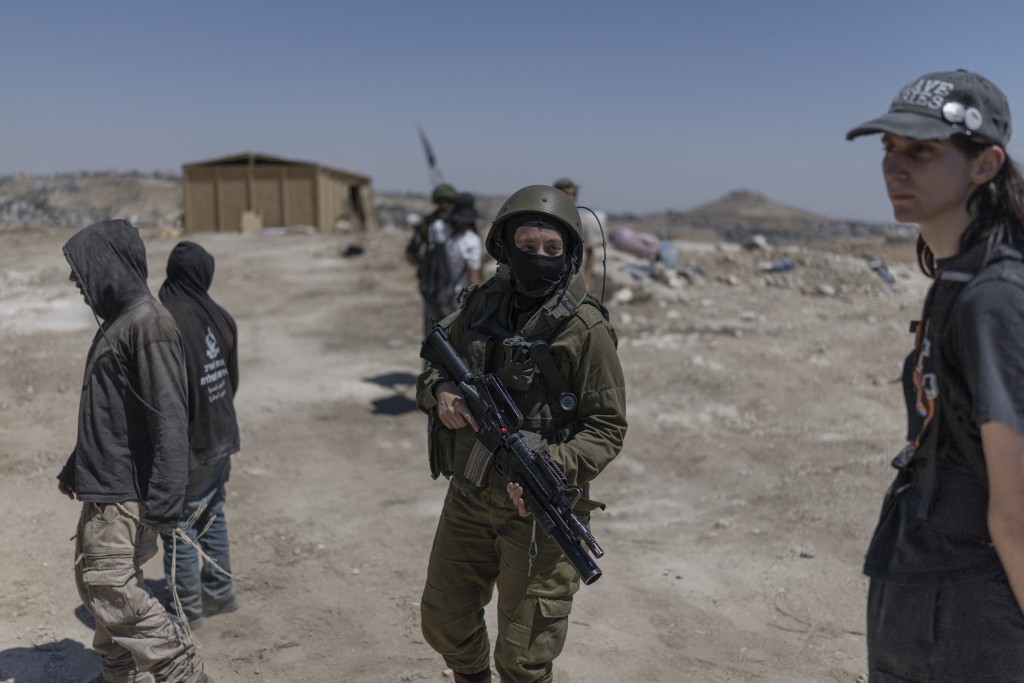 Israeli security arrive as left-wing activists and Israeli settlers scuffle at an Israeli outpost near the Israeli-occupied Palestinian village of Jannatah, south of Bethlehem, on August 25, 2026.