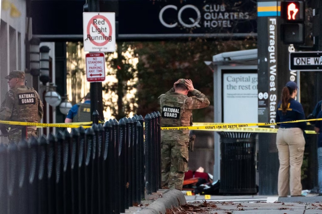  National Guard members stand together behind yellow tape, after two National Guard members were shot near the White House in Washington, D.C., U.S., November 26, 2025. REUTERS/Nathan Howard