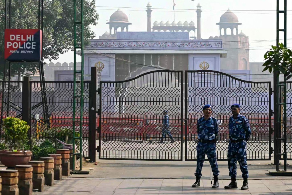 Photo by ARUN SANKAR / AFP  Rapid action force personnel stand guard near the blast site, after an explosion in the Red Fort area in the old quarters of Delhi, on November 12, 2025.