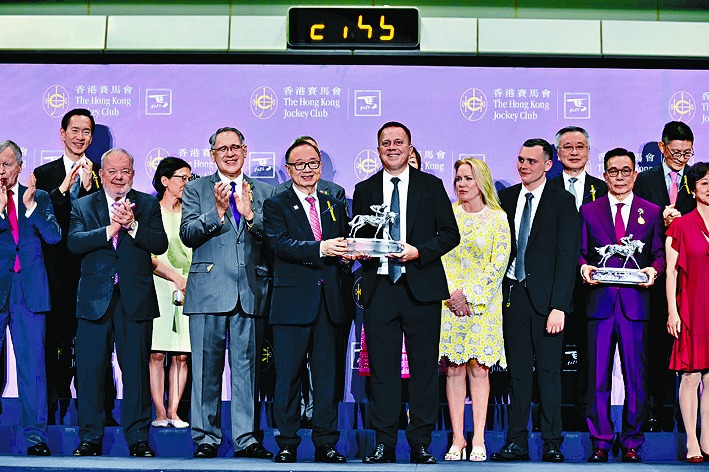 Fownes, front row, center, was recently crowned Hong Kong Champion Trainer for the fifth time.