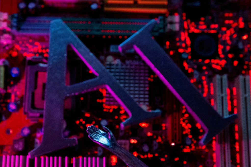 AI (Artificial Intelligence) letters and robot hand are placed on computer motherboard in this illustration created on June 23, 2023. REUTERS/Dado Ruvic
