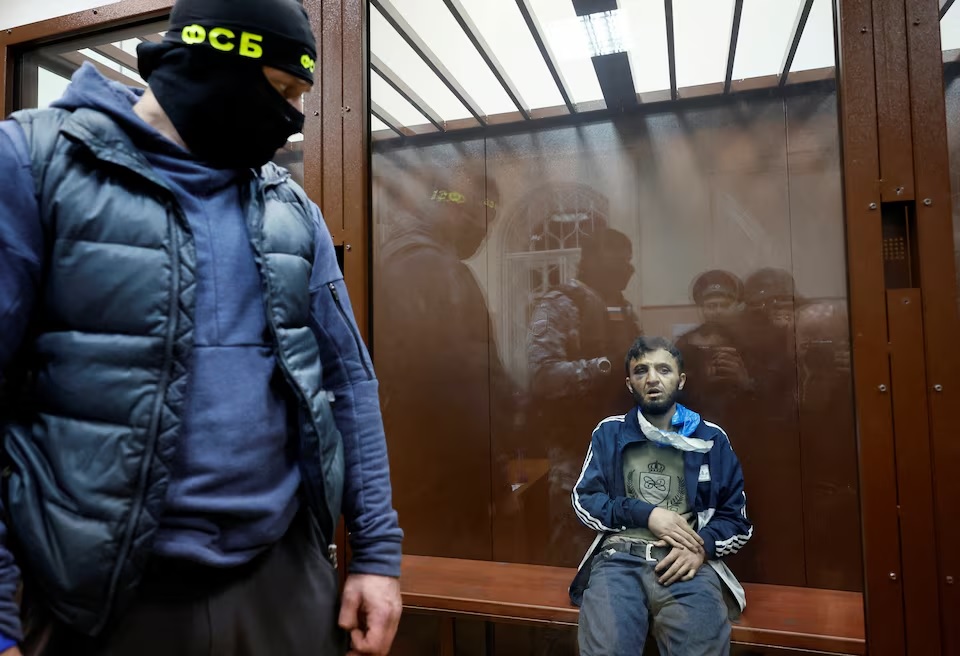 Dalerdzhon Mirzoyev, a suspect in the shooting attack at the Crocus City Hall concert venue, sits behind a glass wall of an enclosure for defendants at the Basmanny district court in Moscow, Russia March 24, 2024. (REUTERS/Shamil Zhumatov)