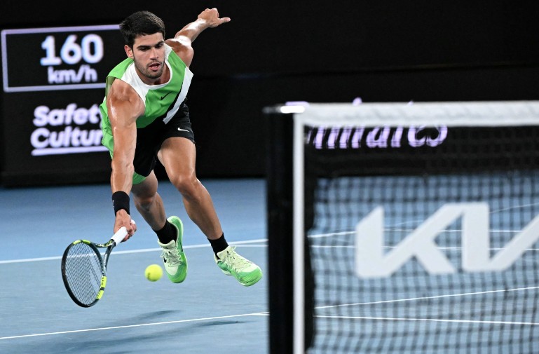 Carlos Alcaraz stretches for a return. AFP