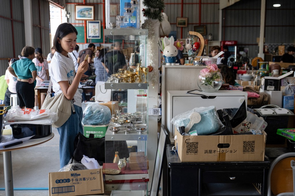 Photo by LILLIAN SUWANRUMPHA / AFP  This photo taken on May 30, 2026 shows customers looking at goods at a Japanese second-hand goods warehouse store in Nonthaburi.
