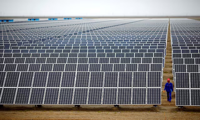 A worker inspects solar panels at a solar farm in Dunhuang, 950km (590 miles) northwest of Lanzhou, Gansu Province. (Reuters) A worker inspects solar panels at a solar farm in Dunhuang, 950km (590 miles) northwest of Lanzhou, Gansu Province. (Reuters)