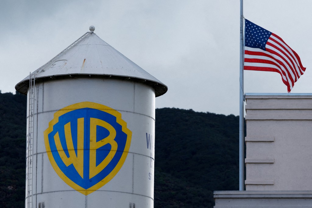 The Warner Bros. studios water tower stands next to a U.S. flag in Burbank, California, U.S. November 18, 2025.  REUTERS