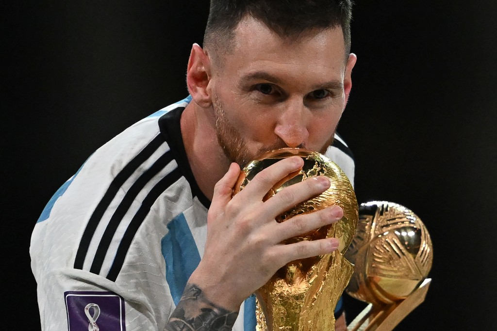 Photo by PAUL ELLIS / AFP  Argentina's captain and forward #10 Lionel Messi kisses the FIFA World Cup Trophy during the trophy ceremony after Argentina won the Qatar 2022 World Cup final football match between Argentina and France at Lusail Stadium in Lusail, north of Doha on December 18, 2022.