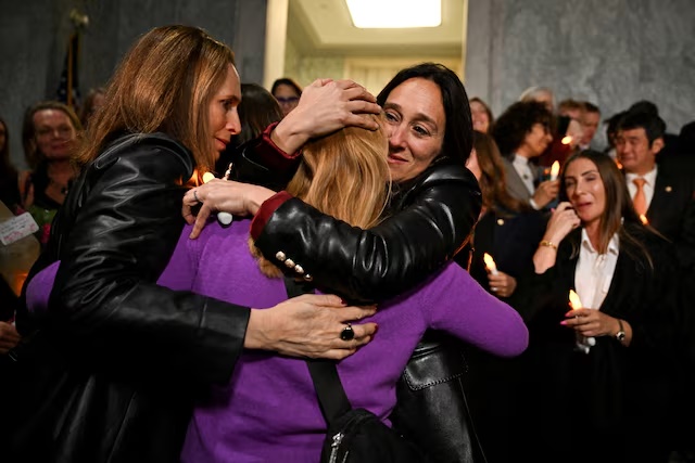 National Director of World Without Exploitation Lauren Hersh embraces Jeffrey Epstein survivor Liz Stein as they react to the Senate's passing of the bill. REUTERS/Annabelle Gordon 