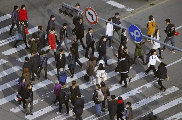 People cross a zebra crossing in a business district in central Seoul, South Korea, December 15, 2015. Picture taken on December 15, 2015. REUTERS/Kim Hong-Ji/File Photo People cross a zebra crossing in a business district in central Seoul, South Korea, December 15, 2015. Picture taken on December 15, 2015. REUTERS/Kim Hong-Ji/File Photo