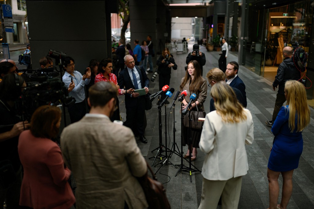 Photo by GEORGE CHAN / AFP  Sheina Gutnick, whose father was killed in a mass shooting at Bondi Beach, speaks to the media after the first hearing block of the Royal Commission on Antisemitism and Social Cohesion in Sydney on May 4, 2026.