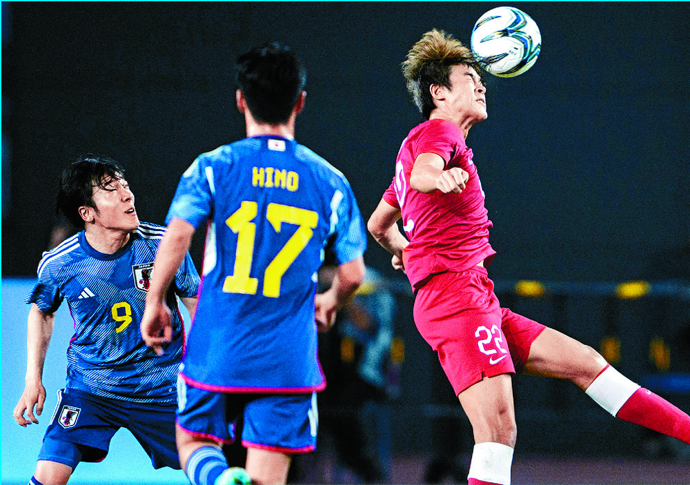 Ellison Tsang jumps for the ball. Hong Kong players are unbowed after the semi-final defeat by Japan. AFP