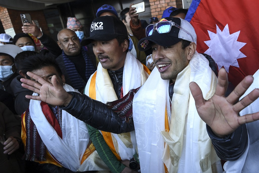 Nepali mountaineer Nirmal Purja (R) talks to the media along with his team. (AFP/File)