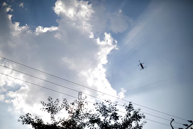 A military helicopter carrying a container flies toward a golf course where a Terminal High Altitude Area Defense (THAAD) system is deployed, in Seongju, South Korea, June 14, 2017. REUTERS/Kim Hong-Ji/File Photo