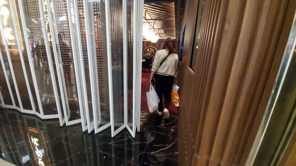 Staff members are spotted carrying luggage for their stay at the quarantine center. 