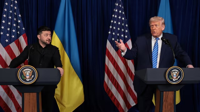 Ukrainian President Volodymyr Zelenskiy listens to U.S. President Donald Trump, after Trump said that Russian President Vladimir Putin expressed willingness to help Ukraine "succeed", during a press conference at Trump's Mar-a-Lago club, in Palm Beach, Florida, U.S., December 28, 2025. REUTERS/Jonathan Ernst