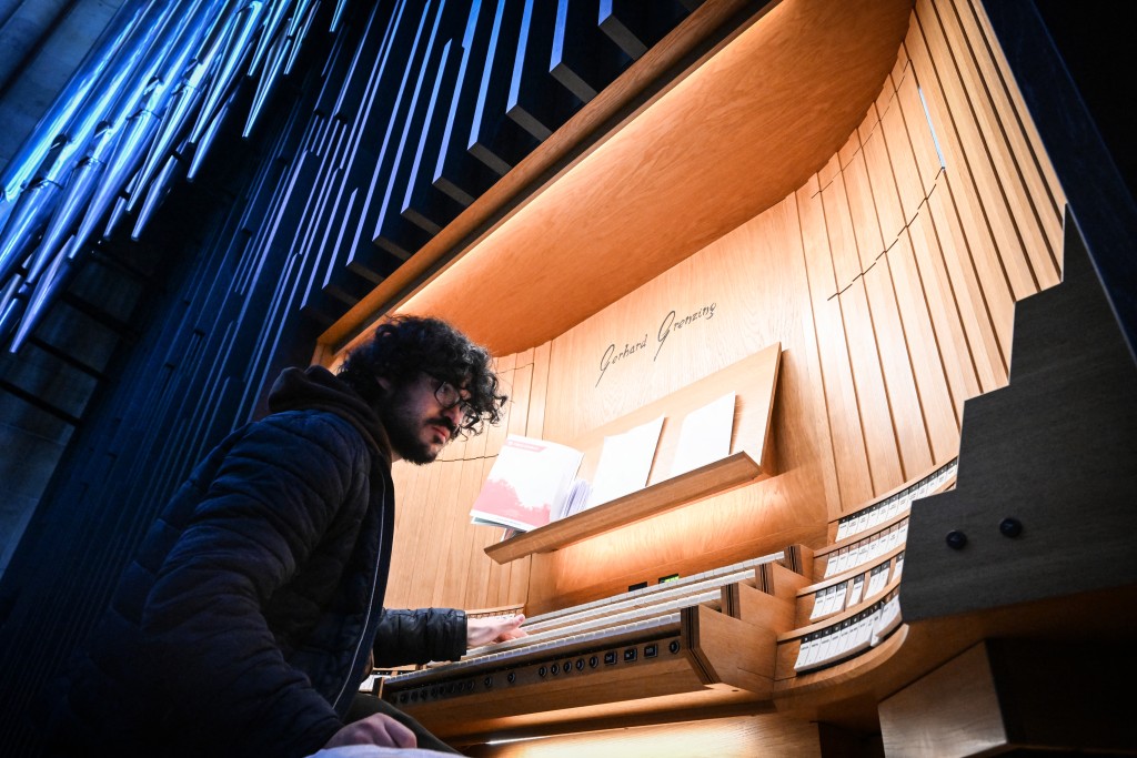 Photo by MICHAL CIZEK / AFP  This photo taken on November 5, 2025 shows pipes chief intoner Andre Lacroix tuning the new organ in St Vitus Cathedral at Prague Castle, Czech Republic.