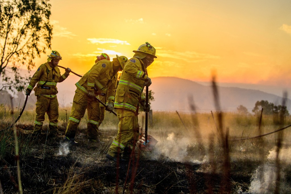 CFA firefighters conduct black-out operations at dusk as they mop up remaining hot spots following bushfire activity near Alexandra, Victoria, Australia, as extreme fire danger conditions persist across the state, January 10, 2026. (Reuters)