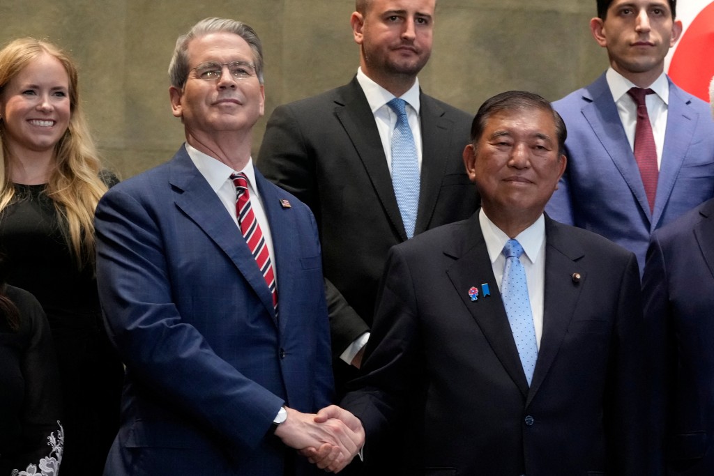 Japanese Prime Minister Shigeru Ishiba shakes hands with U.S. Treasury Secretary Scott Bessent, before their meeting at the prime minister's office in Tokyo, Japan, Friday, July 18, 2025. Shuji Kajiyama/Pool via REUTERS