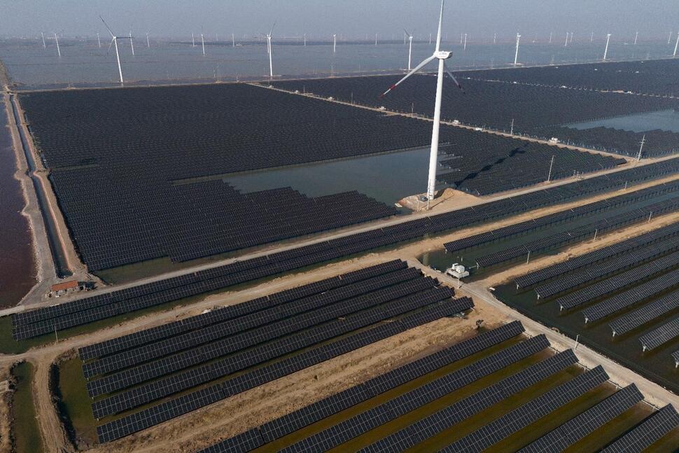 FILE - Wind turbines dot the coast line along a giant solar farm near Weifang in eastern China's Shandong province on March 22, 2024. (AP Photo/Ng Han Guan, File) FILE - Wind turbines dot the coast line along a giant solar farm near Weifang in eastern China's Shandong province on March 22, 2024. (AP Photo/Ng Han Guan, File)