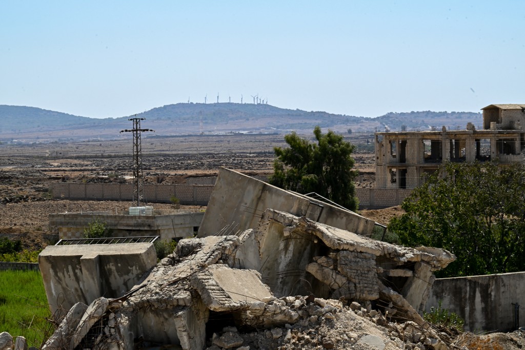 This picture shows buildings destroyed during Israeli bombardment in the city of Madinat al-Salam (City of Peace) formerly known as Madinat al-Baath until the fall of president Bashar al-Assad, on the Damascus-Quneitra road, in the administrative centre of the Quneitra governorate of southern Syria, on the edge of the Israeli-annexed Golan Heights on September 21, 2025.  (Photo by LOUAI BESHARA / AFP)