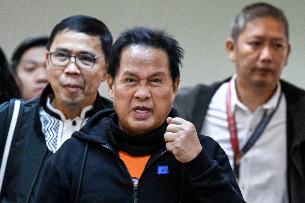 Photo by JAM STA ROSA / AFP  Apollo Quiboloy (C), pastor and founder of the Philippine-based Kingdom of Jesus Christ (KOJC) church, arrives to attend a hearing at the Senate in Manila on October 23, 2024, over accusation charges of human trafficking and sexual abuse of a minor.