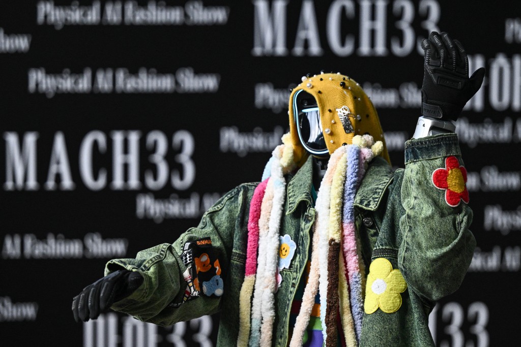A humanoid robot presents creations at Galaxy Corporation's "Mach33: Physical AI Fashion Show" in Seoul on May 28, 2026. (Photo by Pedro PARDO / AFP)