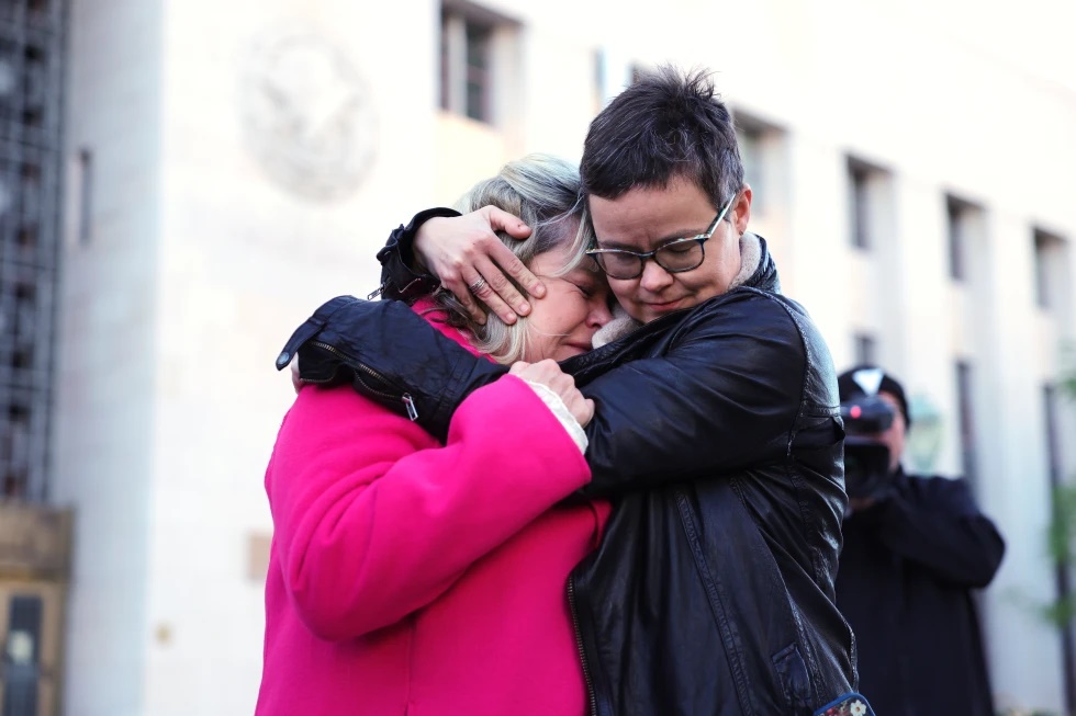  Lennon Flowers, right, Project Director of The Parents’ Network hugs Lori Schott, mother of Annalee Schott, outside a landmark trial over whether social media platforms deliberately addict and harm children, Wednesday, Feb. 18, 2026, in Los Angeles. (AP Photo/Ryan Sun)