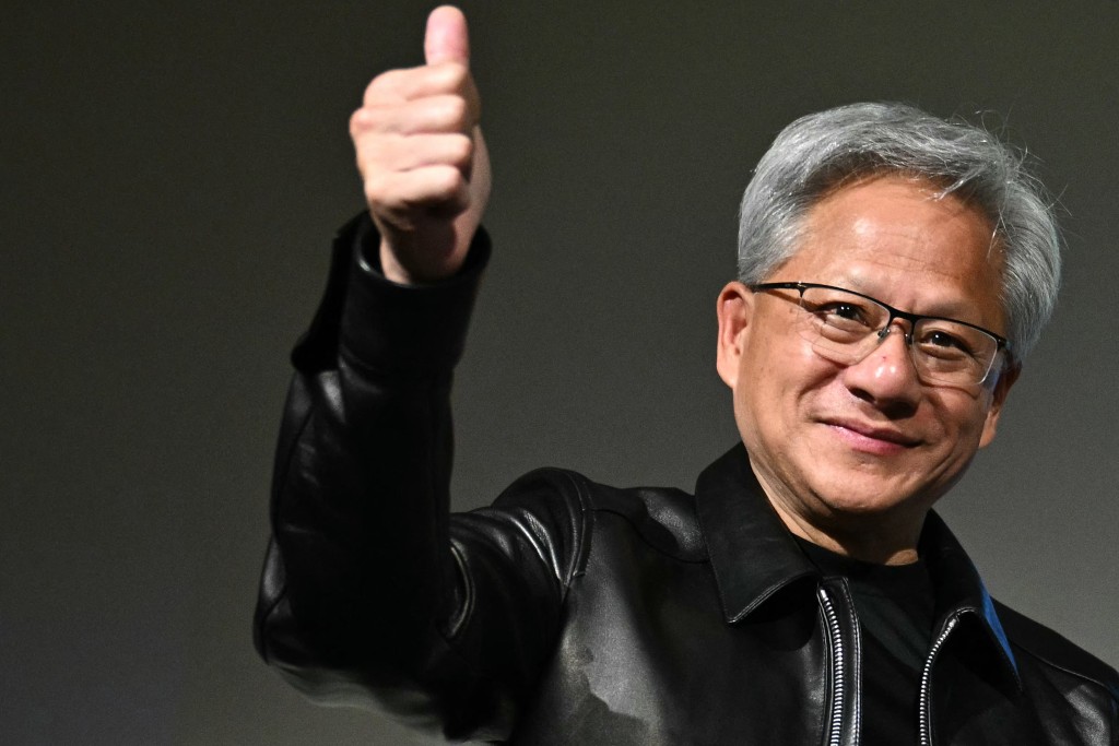 Photo by PHILIP FONG / AFP  Nvidia CEO Jensen Huang gives a thumbs up at a press conference with Japanese multinational information and communications technology company Fujitsu in Tokyo on July 16, 2026.