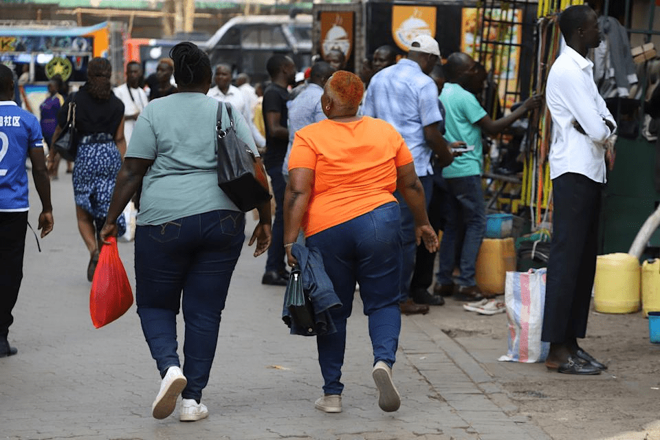FILE - Women walk in the streets of Nairobi, Kenya, during World Obesity Day, March 4, 2025. (AP Photo/Andrew Kasuku, File)