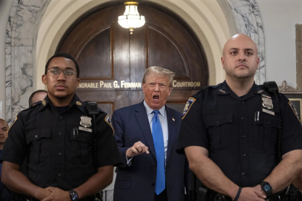 He addressed the media assembled outside the courtroom multiple times throughout the day. (AP) He addressed the media assembled outside the courtroom multiple times throughout the day. (AP)