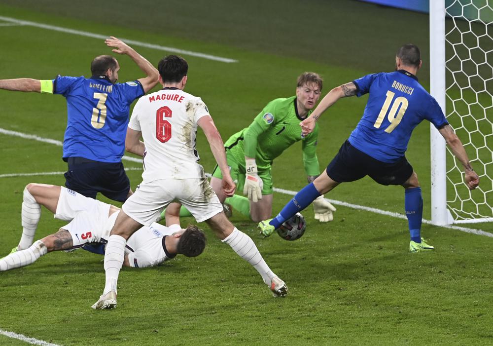 Italy's Leonardo Bonucci, right, scores his side's opening goal during the Euro 2020 final soccer match between Italy and England at Wembley stadium in London, Sunday, July 11, 2021.