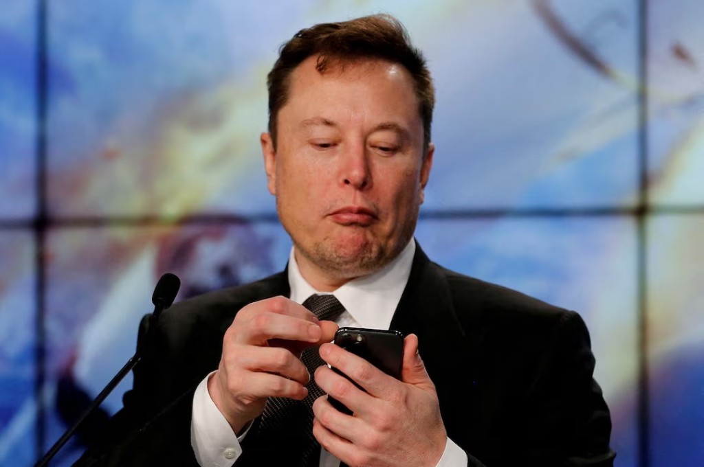 Elon Musk looks at his mobile phone in Cape Canaveral, Florida, U.S. January 19, 2020.