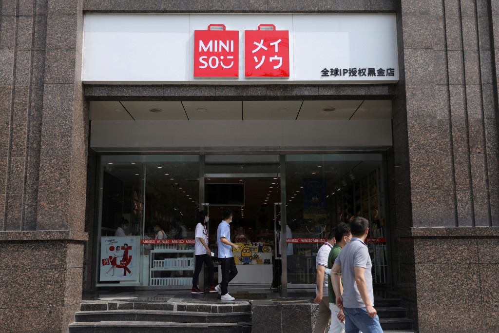 People walk past a store of Chinese retailer MINISO Group in Beijing, China September 13, 2021. Picture taken September 13, 2021. REUTERS