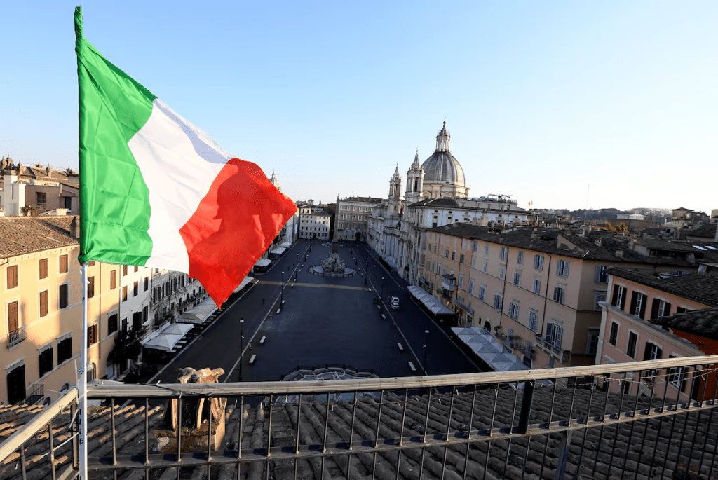 An Italian flag flutters in front of Piazza Navona, as Italians remain under lockdown to prevent the spread of the coronavirus disease (COVID-19), in Rome, Italy, April 4, 2020. REUTERS/Alberto Lingria 