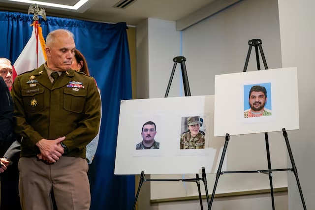Pictures of two National Guard members and a picture of a suspect at a press conference in Washington, D.C., U.S., November 27, 2025. REUTERS/Nathan Howard 