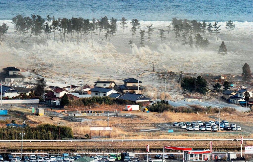 A massive tsunami sweeps in to engulf a residential area after a powerful earthquake in Natori, Miyagi Prefecture in northeastern Japan  March 11.  REUTERS/KYODO