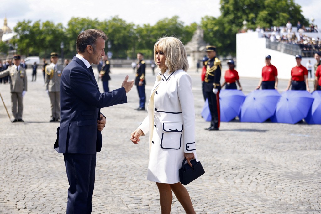 French President Emmanuel Macron and his wife Brigitte leave the annual Bastille Day military ceremony during celebrations to mark Bastille Day in Paris, France, July 14, 2025. (Reuters)