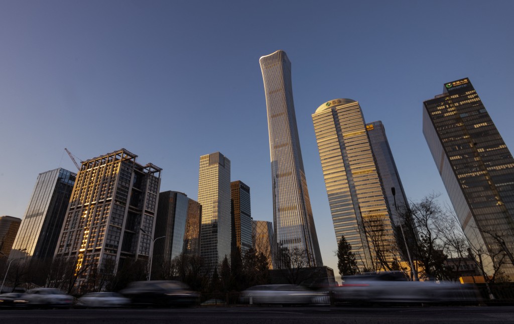 Cars drive along the road next to skyscrapers of the Central Business District (CBD) in Beijing, China, January 5, 2026. REUTERS/Maxim Shemetov