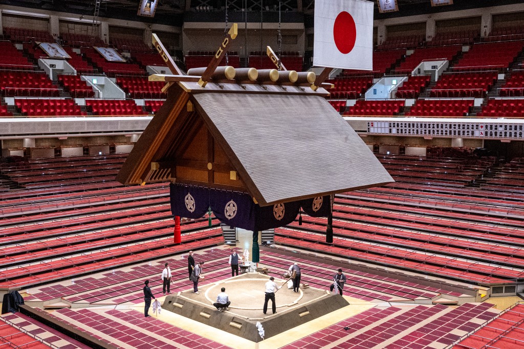 Photo by MATHIAS CENA / AFP  This picture taken on January 10, 2026 shows the sacred clay ring "dohyo", where sumo wrestlers compete, is built at the Ryogoku Kokugikan sumo arena in Tokyo.