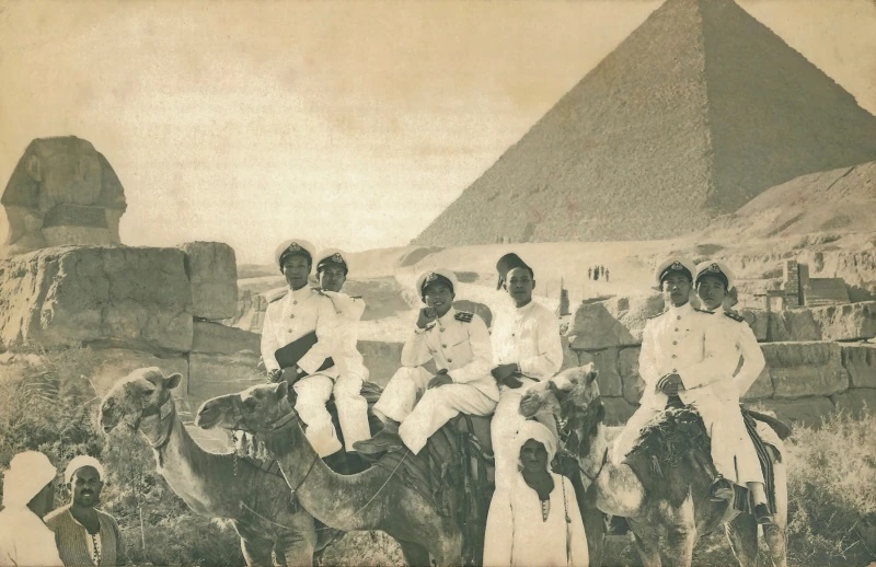 This handout photo provided by Huang Shansong, son of Huang Tingxin, one of the 24 officers sent to Britain, Chinese naval officers pose for a photo in front of a pyramid on Sept. 8, 1943, in Egypt during their journey to Britain for training. (Huang Shansong via AP)