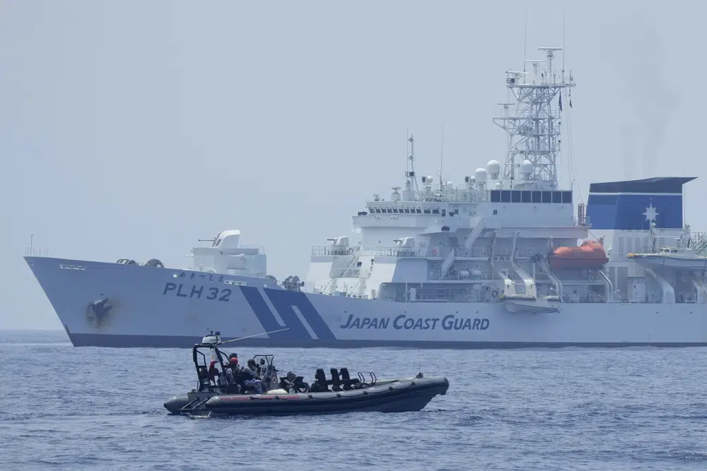 A Philippine Coast Guard rigid hull inflatable boat passes by the Japanese Coast Guard Akitsushima (PLH-32) during a trilateral Coast Guard drill off the waters in Bataan province, Philippines, Tuesday, June 6, 2023. (AP) A Philippine Coast Guard rigid hull inflatable boat passes by the Japanese Coast Guard Akitsushima (PLH-32) during a trilateral Coast Guard drill off the waters in Bataan province, Philippines, Tuesday, June 6, 2023. (AP)