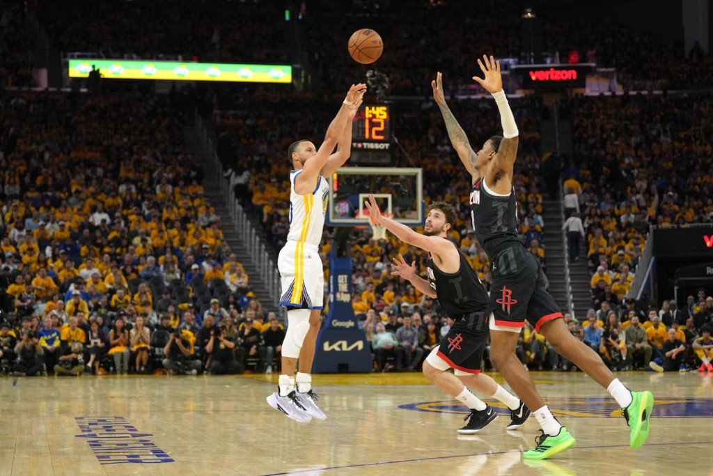 Golden State Warriors guard Stephen Curry (left) shoots against Houston Rockets center Alperen Sengun (center right) and forward Jabari Smith Jr. (right) during the second quarter of game three. (Reuters)