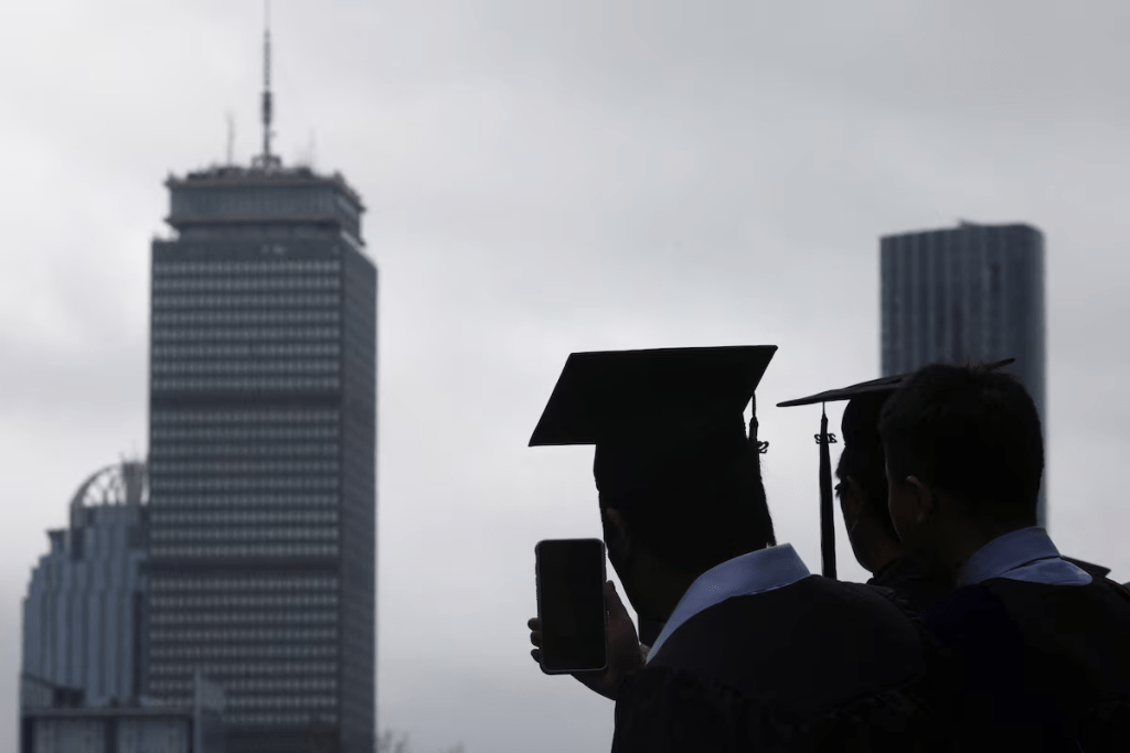A graduating student records the academic procession during the Commencement ceremony at the Massachusetts Institute of Technology (MIT) in Cambridge, Massachusetts, U.S., May 27, 2022. REUTERS/Brian Snyder/File Photo
