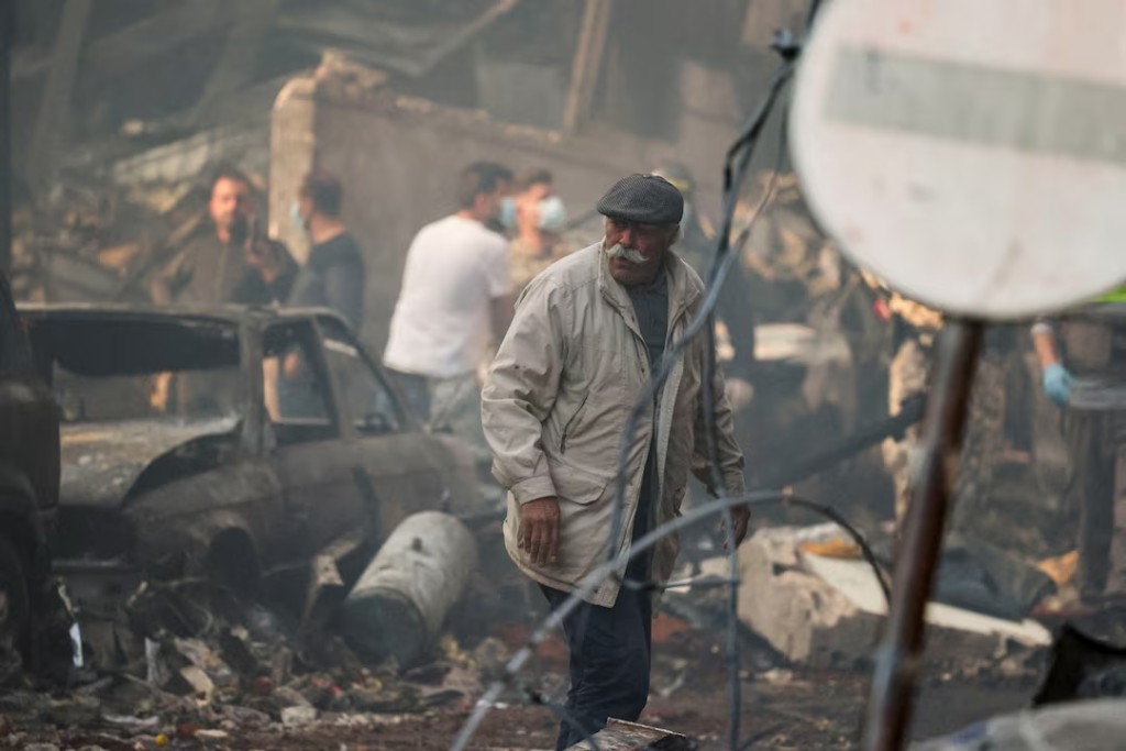 A man walks at the site of an Israeli strike, in Al-Mazraa in Beirut, Lebanon. REUTERS/Yara Nardi