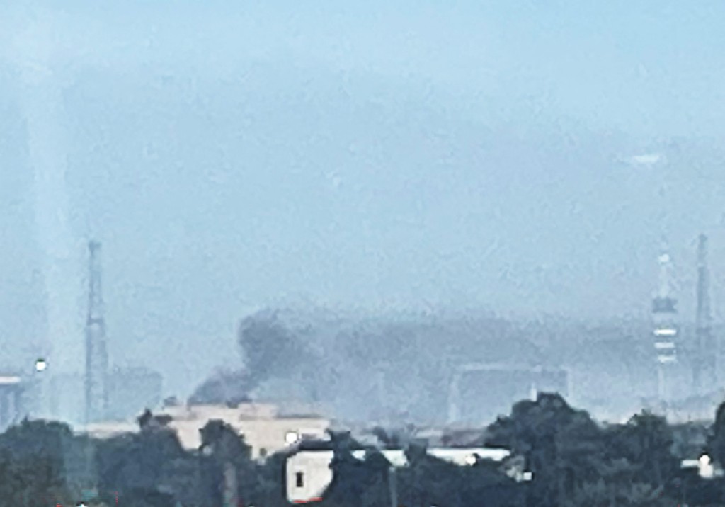 Photo by - / AFP  Smoke rises following a drone attack on the US embassy in Baghdad on March 14, 2026.