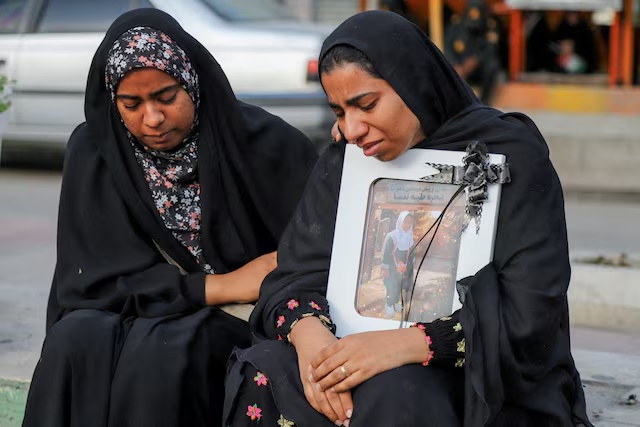 People mourn on the day of the funeral of the victims following a reported strike on a school in Minab, Iran, March 3, 2026. Amirhossein Khorgooei/ISNA/WANA (West Asia News Agency) via REUTERS 