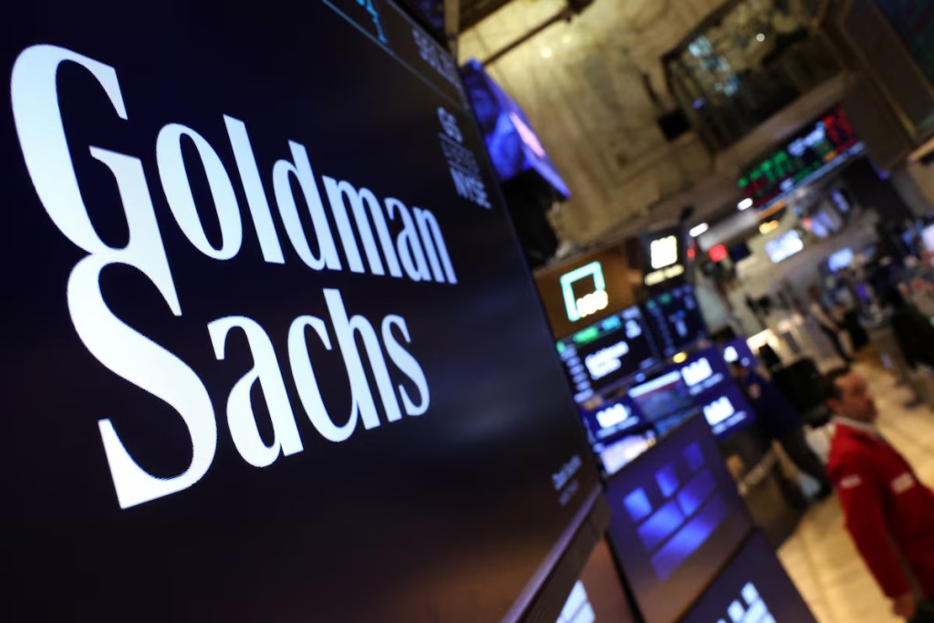 A screen displays the the company logo for Goldman Sachs on the floor at the New York Stock Exchange (NYSE) in New York City, U.S., May 7, 2025. REUTERS